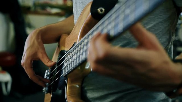 Professional Guitarist Playing Rock Solos An Electric Bass Guitar