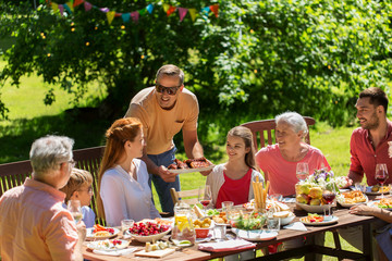 happy family having dinner or summer garden party