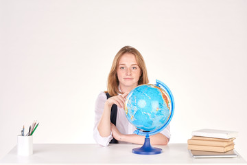 Portrait of red-haired female student studying at desk