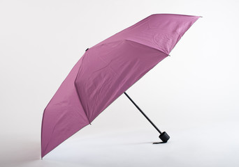 Opened pink umbrella isolated on white background