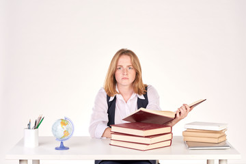 Portrait of red-haired female student studying at desk