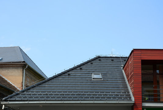 New Shingles Roof with Skylights Windows and Rain Gutter. New brick house with lightning conductor