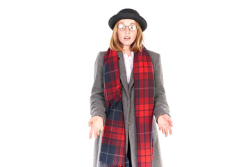 Portrait of teenage hispter girl wearing gray overcoat and black hat isolated on white