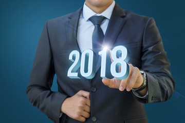 Businessman clicks on 2018.