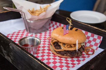 Steak burger with french fries and ketchup on the tray