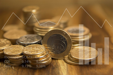 Brazilian coins and graphics. Economic indicators. Selective focus.