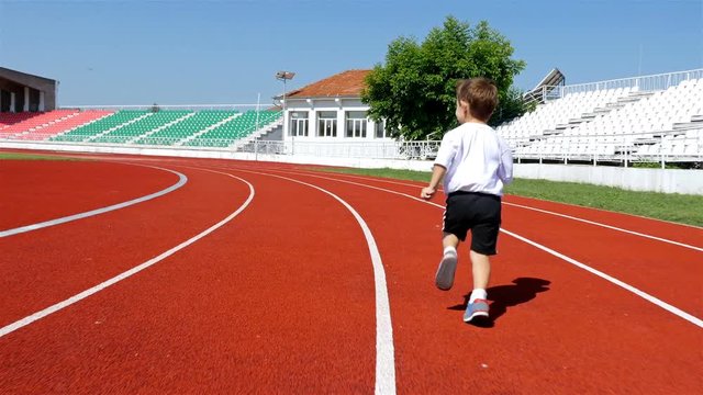 Tracking camera of 3 years old boy running in a stadium, 4k