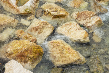 Underwater sea stones, surface with ripples and waves