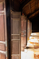 The corridor with old wood windows at Tu Duc tomb in Hue Vietnam