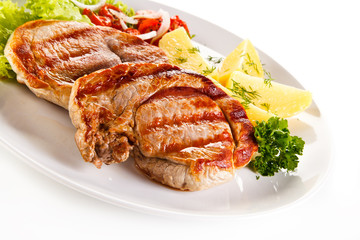 Grilled steak, boiled potatoes and vegetable salad on white background