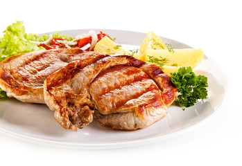 Grilled steak, boiled potatoes and vegetable salad on white background