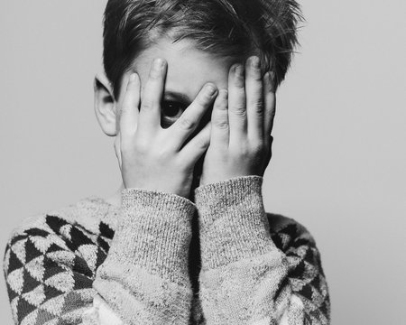 Boy Peeking Through His Fingers
