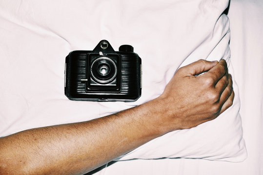 old film camera in bed