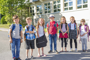 Portrait Of School Pupils Outside Classroom Carrying Bags