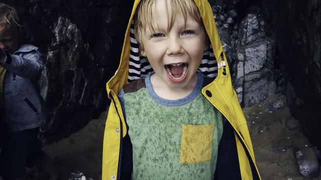 Child sheltering from the rain at the beach