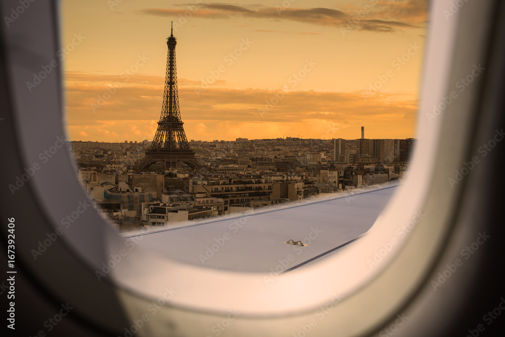 Poster eiffel as seen through window of an aircraft.