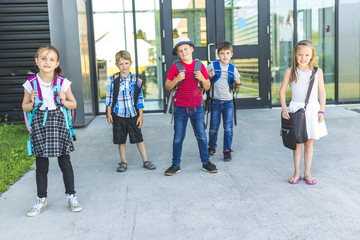 Portrait Of School Pupils Outside Classroom Carrying Bags