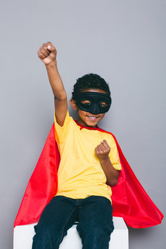 Portrait of a smiling little boy with Superhero costume.