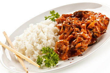 Rice dish with sauce on white background