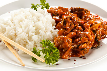 Rice dish with sauce on white background