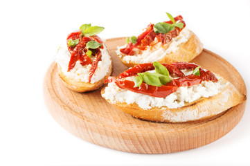 Fototapeta na wymiar Italian sandwiches - bruschetta with cheese, tomato and basil