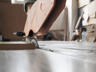 Circular saw. Cut the parts from chipboard on a circular saw at a furniture factory. 
