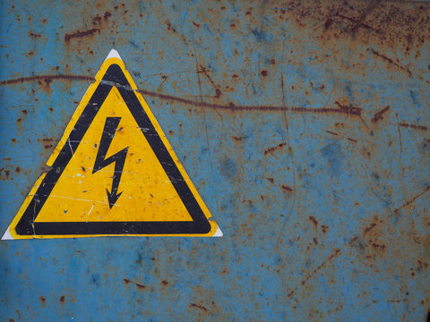 High voltage sign. Old sign danger high voltage on a rusty background.