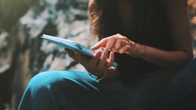 Young Female Student Using a Digital Tablet in Central Park New York City US