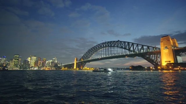 Panning shot of Sydney Harbour Bridge and CBD at night