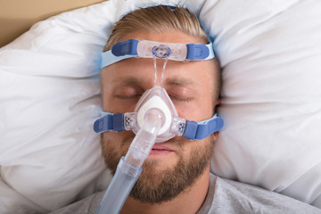 Man With Sleeping Apnea And CPAP Machine