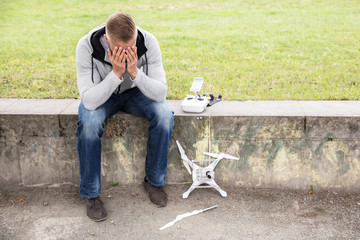 Worried Man With Broken Drone