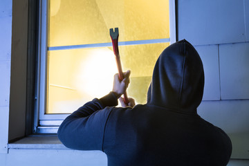 Robber Using The Crowbar To Open The Glass Window