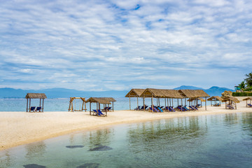 Lounge chairs under tent on beach
