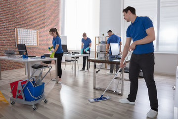 Janitors Cleaning The Office