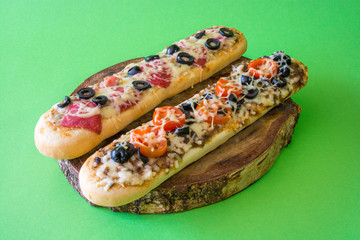 Two sandwiches with cheese on wooden plate