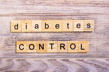 word diabetes on wooden cubes. Control diabetes. On a wooden table