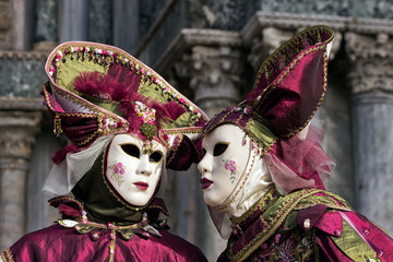 Costumed masked people on the Piazza San Marco during Venice Carnival