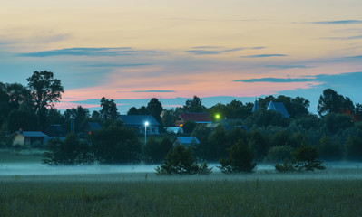 Foggy evening in countryside. Russia