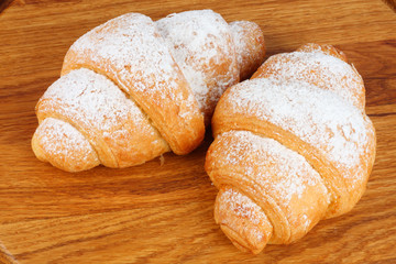 fresh croissant on wooden background