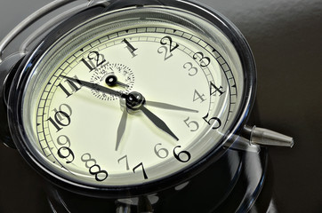 Fast running Time  / close up of   two, overlapping images with  retro alarm clocks, showing different times, horizontal, slanted