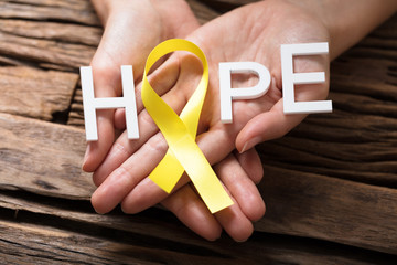 Hand Showing Ribbon With Hope Text