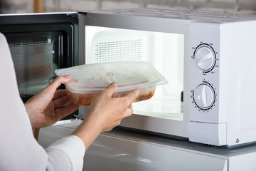 Person Removing Prepared Food