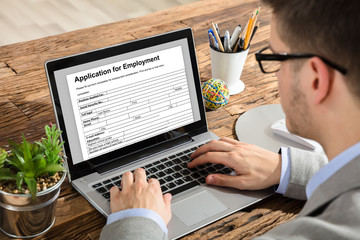 Businessman Filling Application For Employment Form On Laptop