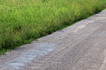 Detail of an unpaved rural road in the countryside close to a field