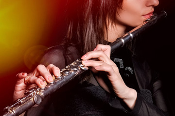 a young girl playing the flute © sushytska