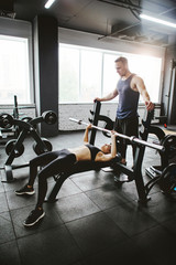 Fototapeta na wymiar Young sporty couple workout in gym