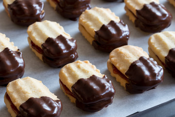 Christmas cookies filled with jam and dipped in chocolate