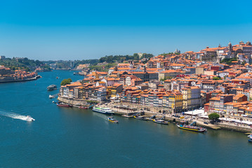 Fototapeta na wymiar Porto in Portugal, the river Douro, colored buildings with tiles roofs 
