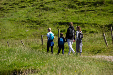 Northern Ireland  landscape, hiking family on pathway, next to a fence