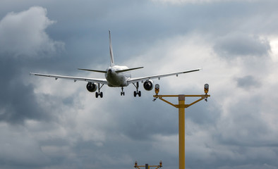 Passenger plane landing on the airport during the stormy weather